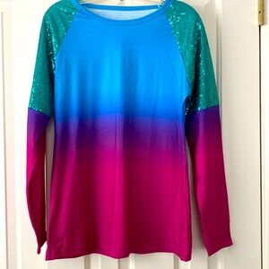 Festive brightly colored top . Sequin trimmed for just enough glam. 27” Length